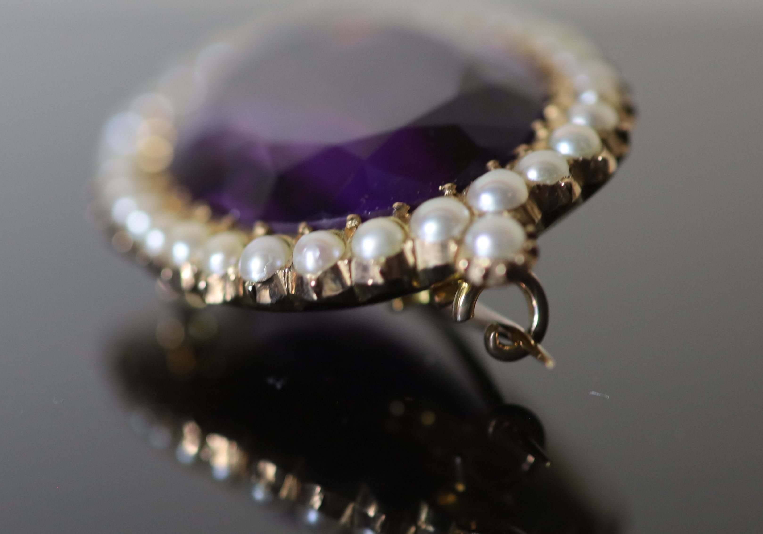 A Victorian style, gold, oval cut amethyst and split pearl cluster set brooch,